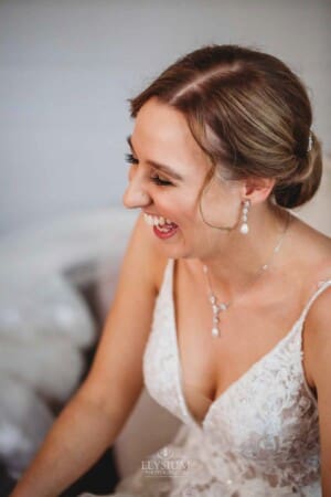 Burnham Grove Wedding - bride has a laugh during wedding prep