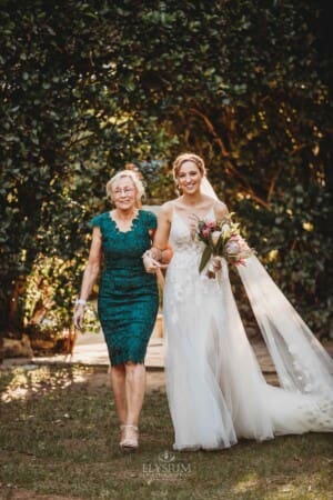 Burnham Grove Wedding - a bride and her mother walk down the aisle