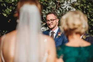 Burnham Grove Wedding - groom watches his bride walk down the aisle