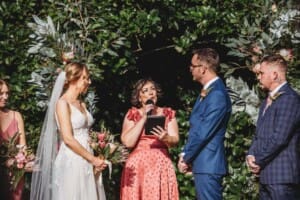 Burnham Grove Wedding - bride and groom stand with their celebrant during the ceremony