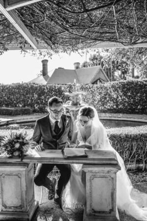 Burnham Grove Wedding - bride and groom sign their marriage certificate