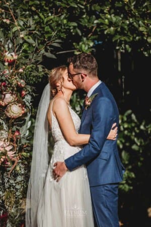 Burnham Grove Wedding - bride and groom share their first kiss