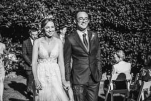 Burnham Grove Wedding - bride and groom walk to sign their marriage certificate