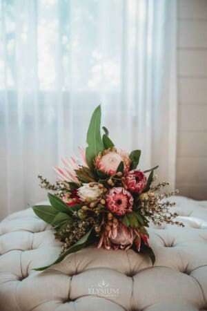 Burnham Grove Wedding - brides flower bouquet sitting in front of a window