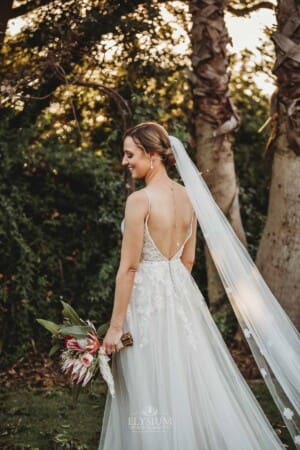 Burnham Grove Wedding - bride stands showing off the details in her dress