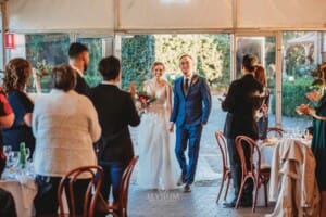 Burnham Grove Wedding - the bride and groom enter their wedding reception