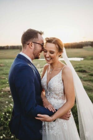 Burnham Grove Wedding - groom whispers in the brides ear as she giggles