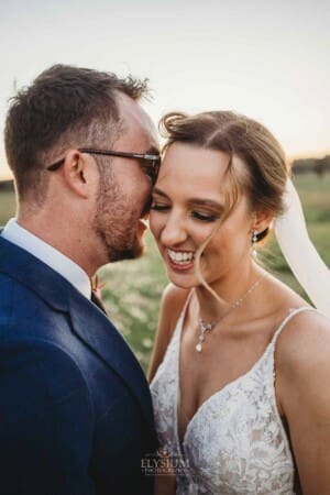 Burnham Grove Wedding - groom whispers in the brides ear as she giggles