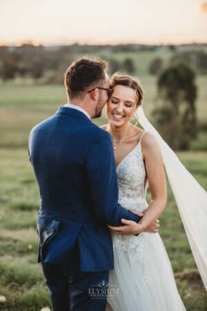 Burnham Grove Wedding - groom whispers in the brides ear as she giggles