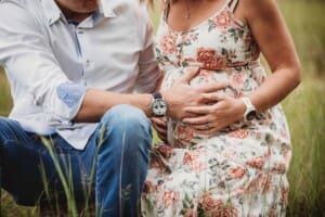 Maternity Photographer - couples hands gently hold the pregnant belly