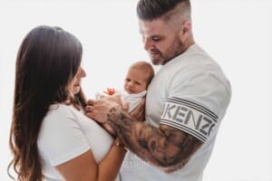 Newborn Photograph - parents cuddle their baby boy between them