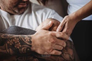 Newborn Photograph - parents gently hold their baby's head