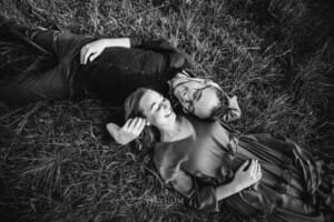 Engagement Photography - a couple lay together in long grass