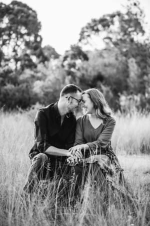 Engagement Photography - a couple sit together and press their foreheads together