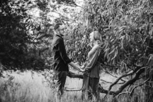 Engagement Photography - a couple holding hands share a laugh