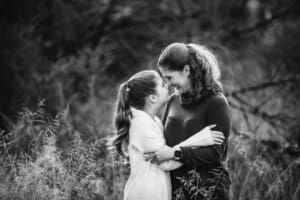 A mother gives her daughter nose kisses