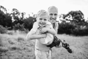 A father zooms his son through the air as they giggle