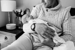 A father holds his newborn baby girl in his arms