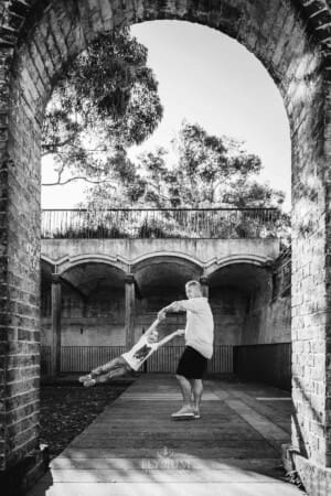 Paddington Gardens, a father holds his son's hands and spins him around