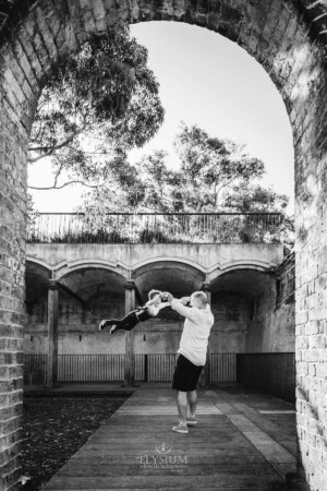 Paddington Gardens, a father spins his son around in the air