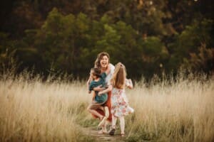 Children run to their mother and give her a big hug
