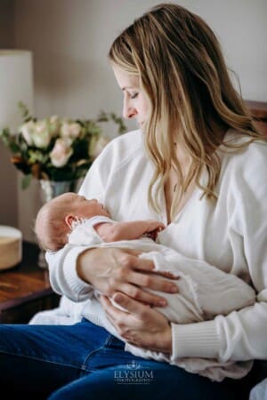 A mothers holds her newborn baby girl in her arms