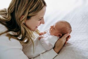 A mother holds her newborn baby girl in her arms