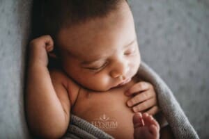 A newborn baby lays sleeping in a great wrap