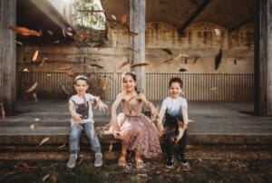 Paddington Gardens, children laugh and throw dried leaves