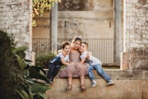 Paddington Gardens, children cuddle together sitting on a stone step