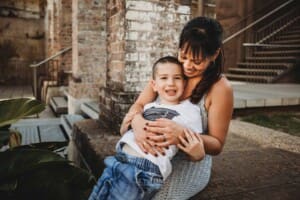 Paddington Gardens, a mother hugs her smiley little boy