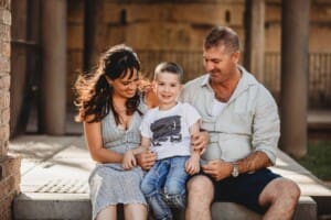 Paddington Gardens, parents cuddle their little boy in their laps