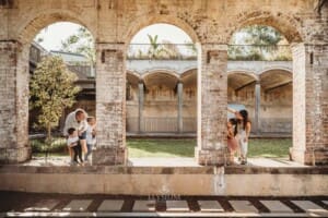 Paddington Gardens, parents and kids peak our from stone arches at each other