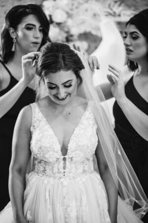 Gledswood Wedding - bridesmaids attach the veil to the brides hair