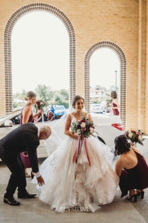 Gledswood Wedding - the bride exiting the car out the front of the church