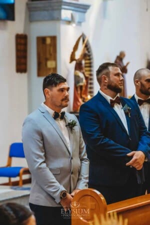 Gledswood Wedding - the groom and groomsmen waiting at the front of the church