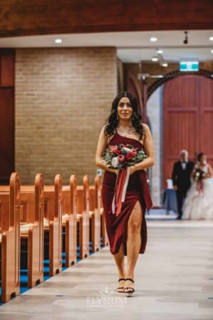 Gledswood Wedding - the bridesmaid walking down the aisle at the ceremony