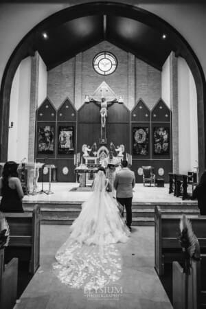 Gledswood Wedding - the bride and groom standing at the front of the church during the ceremony