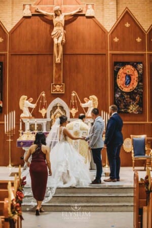Gledswood Wedding - the bride and groom standing at the front of the church during the ceremony