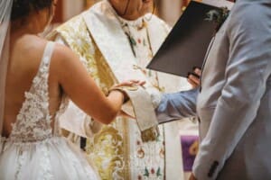 Gledswood Wedding - the priest places his robe over the couples hands during the ceremony