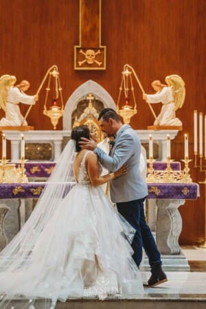Gledswood Wedding - the bride and groom share their first kiss during the ceremony