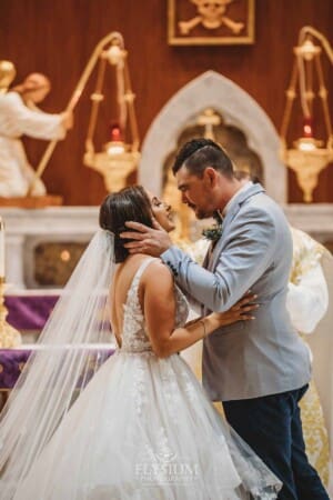 Gledswood Wedding - the bride and groom share their first kiss during the ceremony