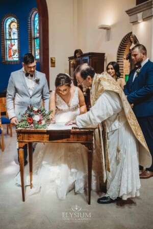 Gledswood Wedding - the bride and groom sign the marriage certificate after the ceremony