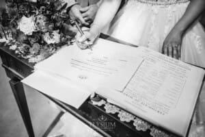 Gledswood Wedding - the bride signs the marriage certificate after the ceremony