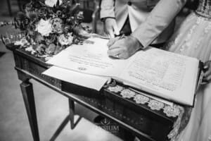 Gledswood Wedding - the groom signs the marriage certificate after the ceremony