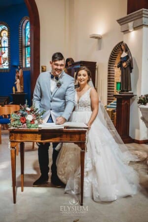 Gledswood Wedding - the bride and groom sign the marriage certificate after the ceremony