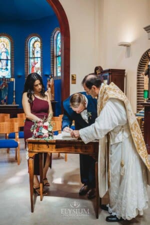 Gledswood Wedding - the witnesses sign the marriage certificate after the ceremony