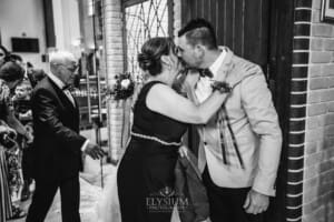 Gledswood Wedding - the groom hugs a wedding guest after the ceremony