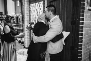 Gledswood Wedding - the groom hugs a wedding guest after the ceremony
