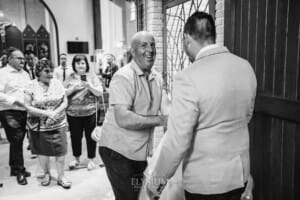 Gledswood Wedding - the groom hugs a wedding guest after the ceremony